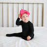 Baby on Black Ribbed Footie Ruffled Zippered One Piece with Pink Headband