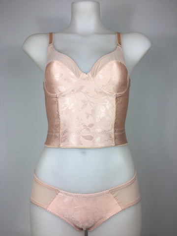 faux vintage inspired longline girdle and front fastening bralette in peachy floral satin fabric. Longline girdle has 6 beige suspender clips holding up seamed nylon stockings. Matching garter belt, longline underwired bra and pantie girdle 