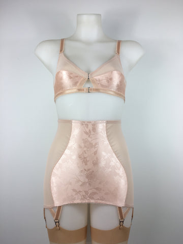 faux vintage 1950s lingerie by pip and pantalaimon. Vintage peachy satin longline girdle with 6 suspender straps with garter clips to keep your seamed nylons in place. Shown with our signature front fastening 1950s inspired soft bralette. The shiny satin peach fabric gives the perfect look to be worn alongside true vintage lingerie