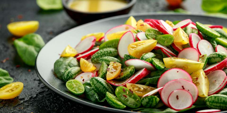 Cucamelons in a salad with tomatoes and radishes