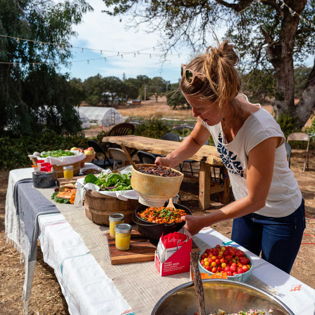 Kate Rutherford sets a table filled with freshly harvested food at a Farm to Crag event outside Yosemite. Raw Roots Farm, Catheys Valley, CA. 