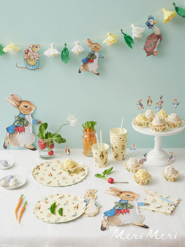 Peter rabbit and friends meri meri party collectioon table set with napkinks, plates, cups and cupcakes.