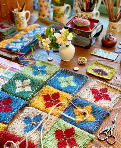 Patchwork knitted squares being sewn together