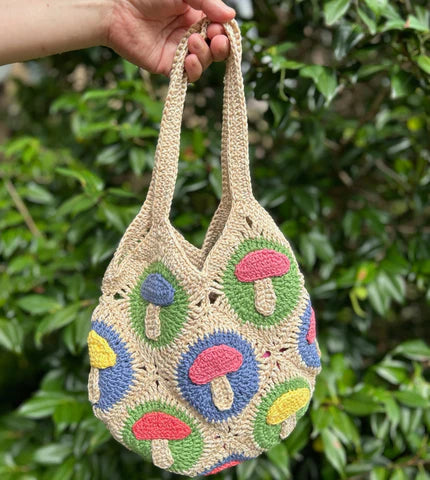 Granny Square Crochet tote bag in beige colour with multi-coloured mushrooms along its length.