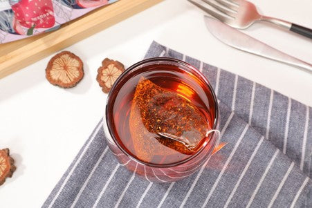 red bush tea in a glass teacup