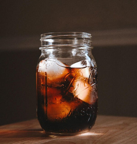 cola drink with ice in a mason jar