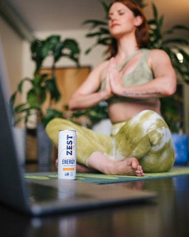 woman drinking Zest tea and meditating