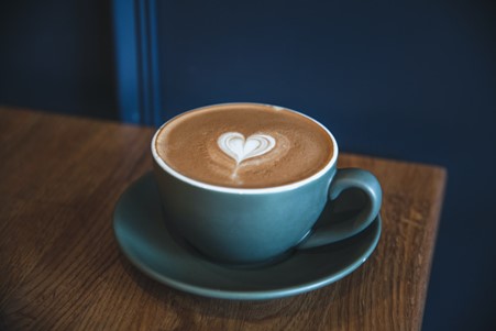 blue cup of coffee with steamed milk