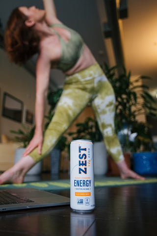woman practicing yoga with zest energy tea