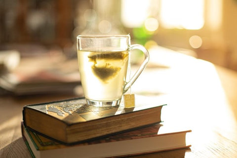 green tea on top of books