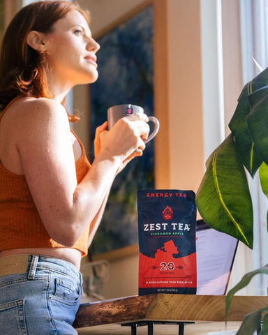 woman enjoying a cup of Zest cinnamon apple tea