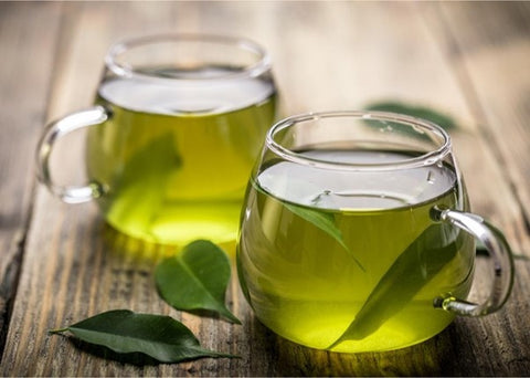 green tea in glass teaware