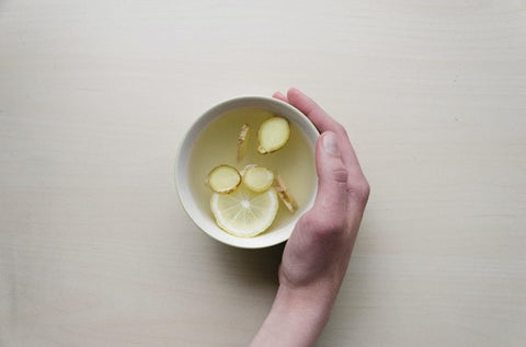 freshly prepared ginger tea in white teacup