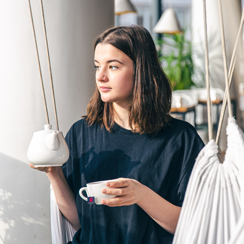 woman feeling relaxed while drinking CBD tea