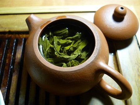 green tea in clay teapot