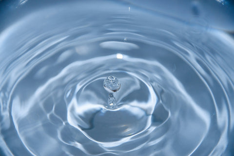 droplet of water falling in a puddle