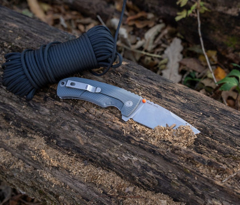 The Tellus FLK - Wolf Gray, a reliable outdoor edge folding knife by SOG, perfect for backcountry adventures.