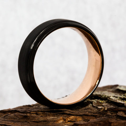 plated wedding ring on piece of wood