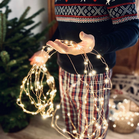 man holding Christmas lights