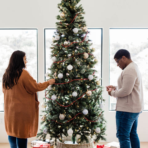 couple decorating a Christmas tree