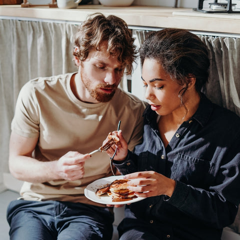 couple sharing a plate of pancakes