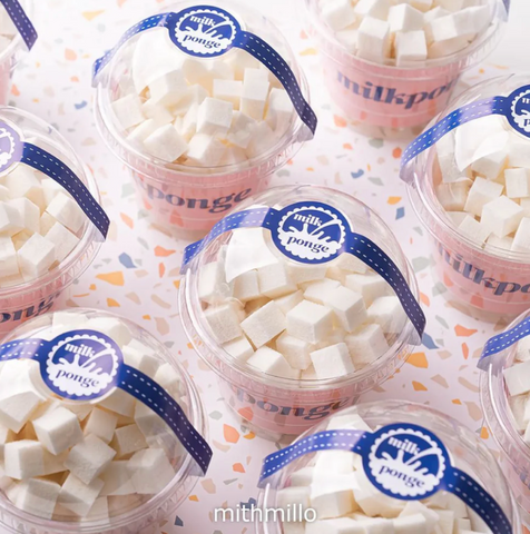 Several plastic containers with blue wrapping, with makeup nail wedges inside.