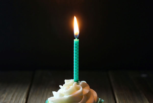 Birthday Cake With A Single Lit Candle