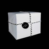 A white corporate gift with black and white string