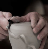 A potter sculpting a vase