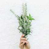 A woman holding a bunch of wild flowers