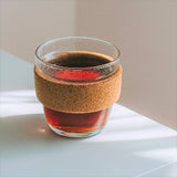 A reusable glass coffee cup