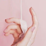 Hand lotion being poured onto a woman's hand