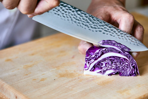 Chef cutting cabbage with Kizaru Kanji Chef Knife