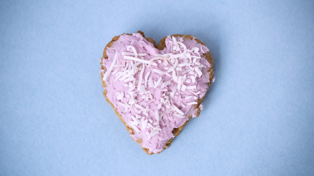 Lavender Valentine Sandwich Cookie with pink frosting and shredded coconut on top