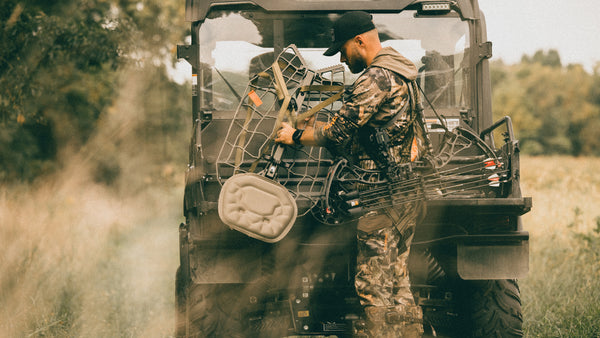 Shawn grabbing a novix treestand out of an ATV