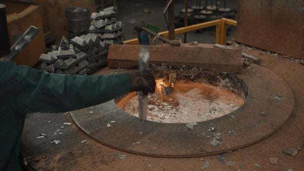 Worker stirring aluminum