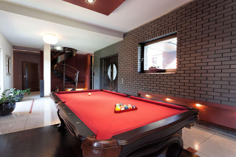 A big red pool table in a luxurious interior