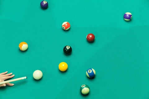 Breaking Pool Balls on green table.