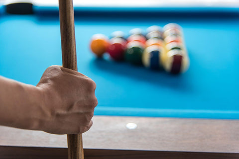 man hand holding snooker stick playing pool or billiards