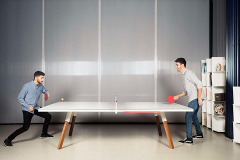 Two men playing ping pong on custom Blatt Billiards ping pong table.