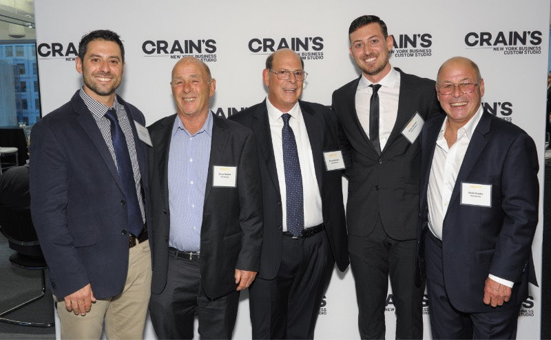 men posing at CRAINS event