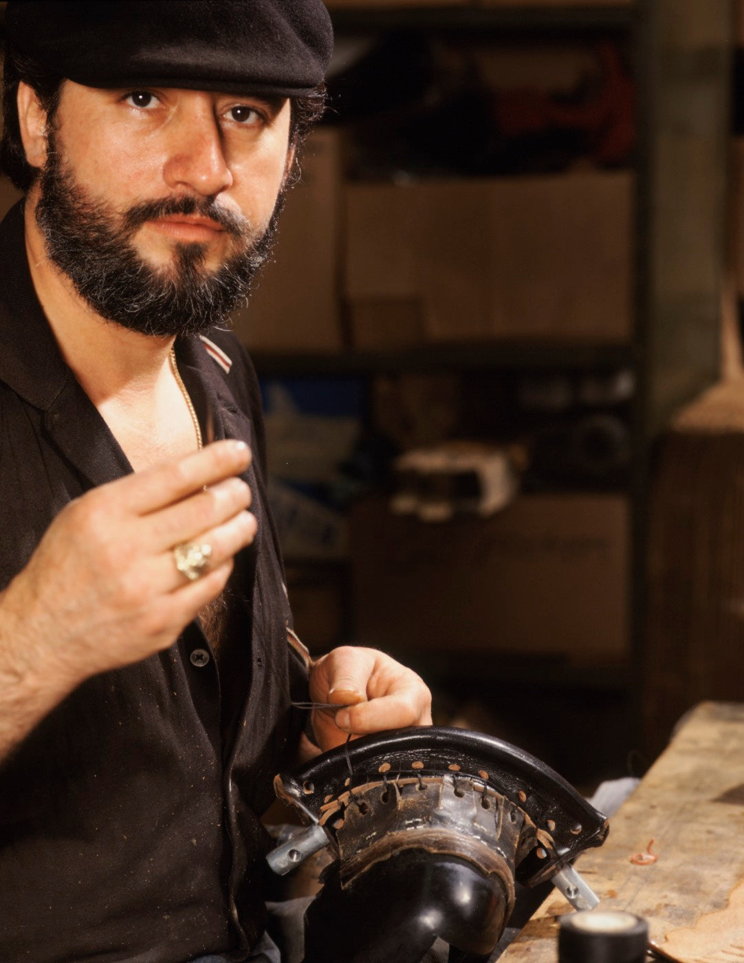 portrait of man leatherworking for pool table