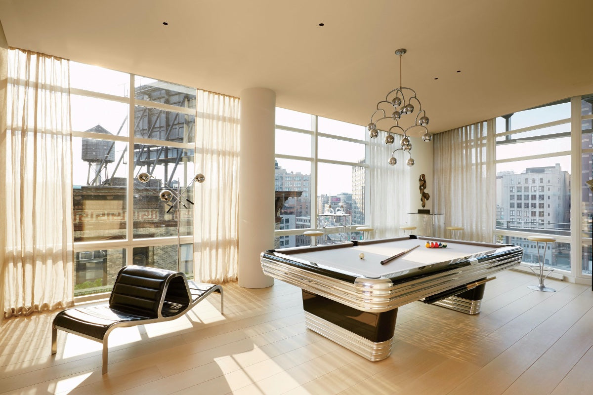 billiards room with windows