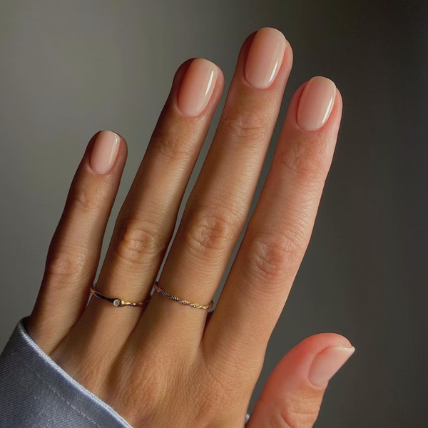 natural short nails with beige nail polish with dainty ring