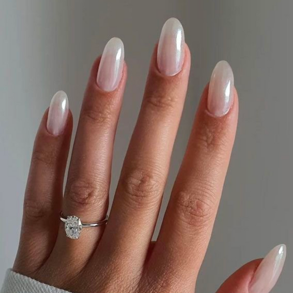 engagement ring on hand with round nails