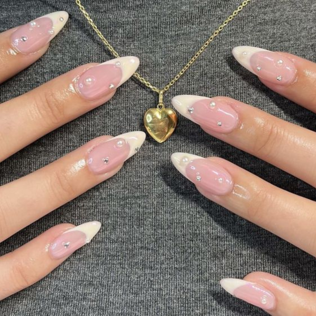 long almond french tip nails with dainty crystals embellishments