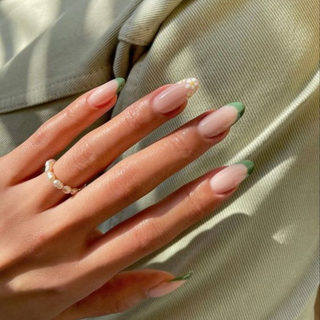 sage french tip nails with floral design on ring finger nail 