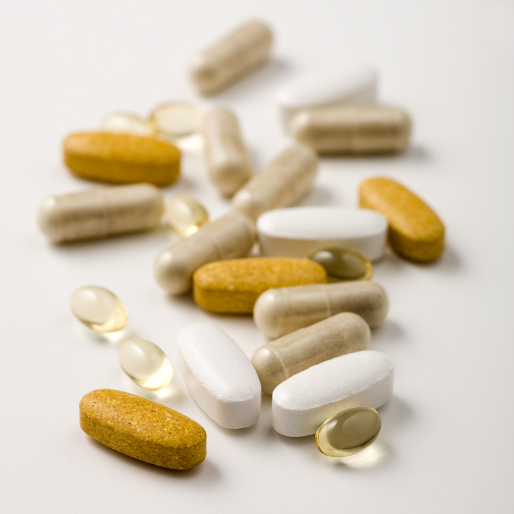 closeup image of a variety of different vitamins and supplement pills