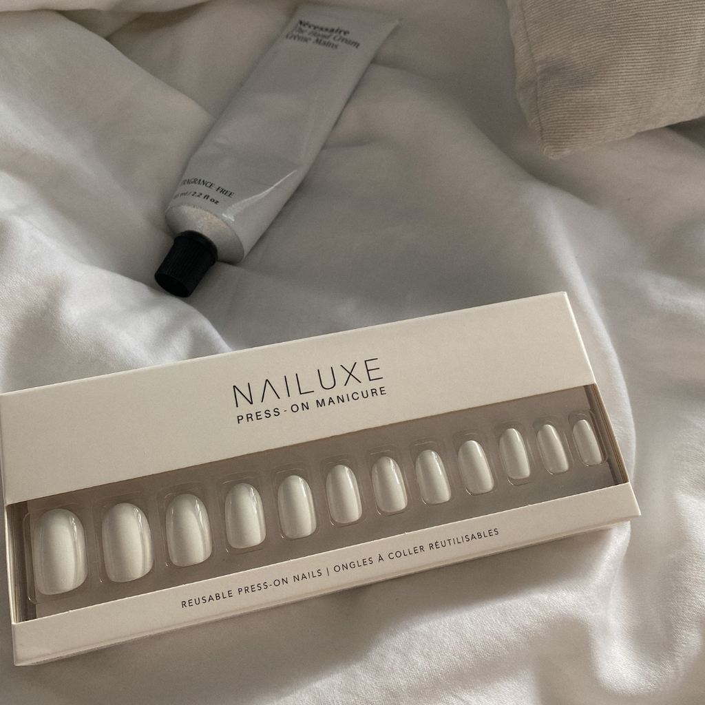 white short round press on nail set in packaging with hand cream 