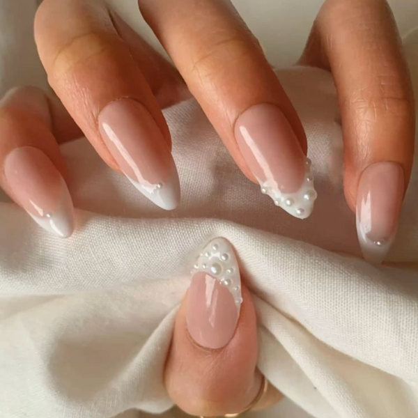 close up of french manicure with pearls